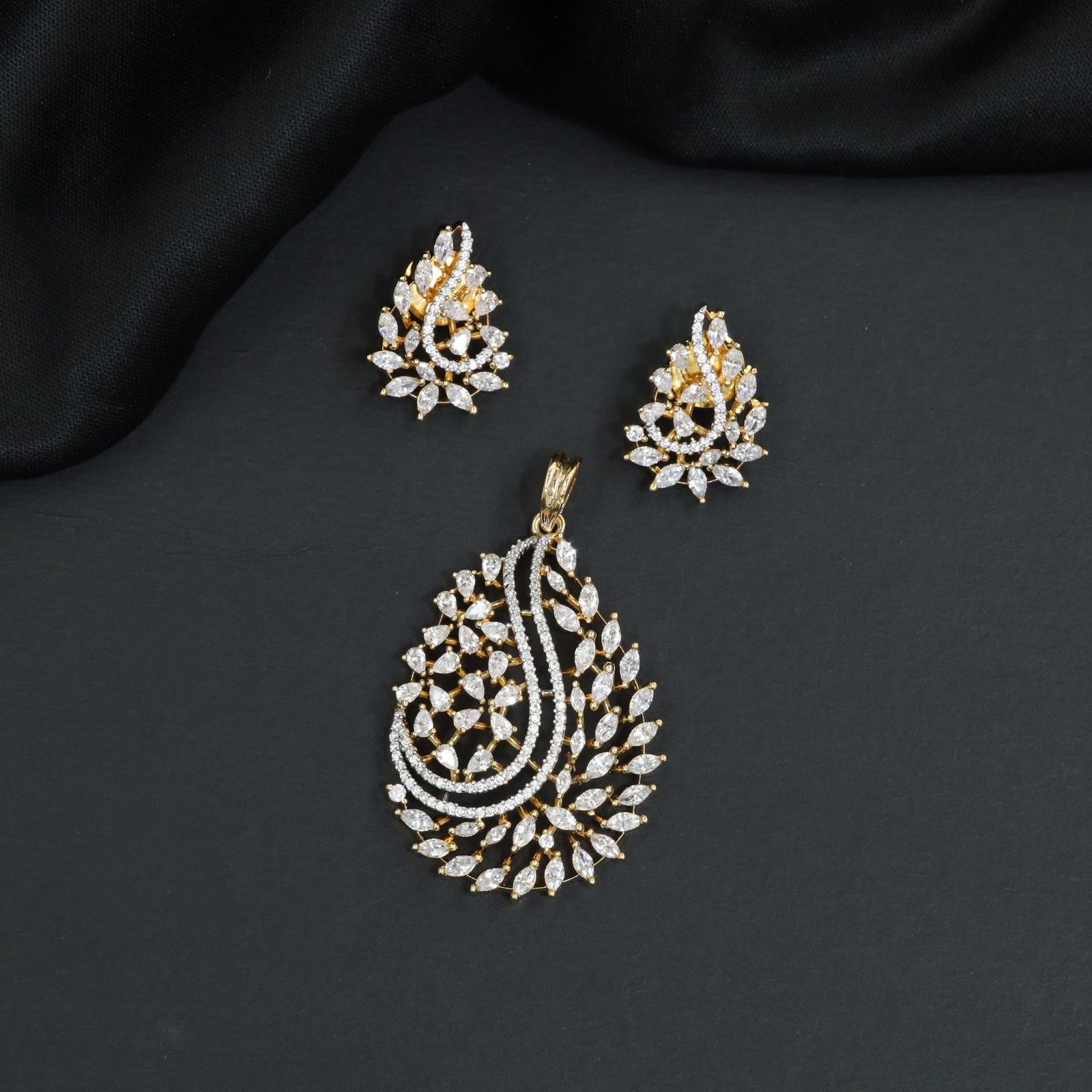 Graceful marquise stone paisley motif pendant set with stone accented top bail
