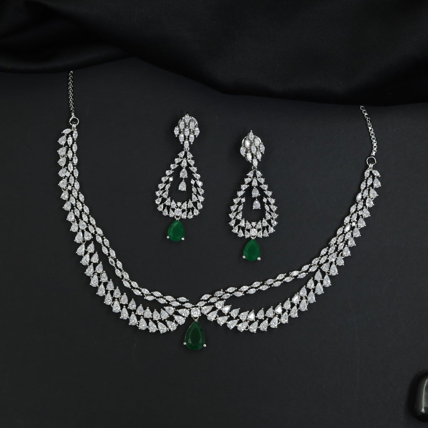 Draped collar rhodium necklace set with pendant drop centerpiece