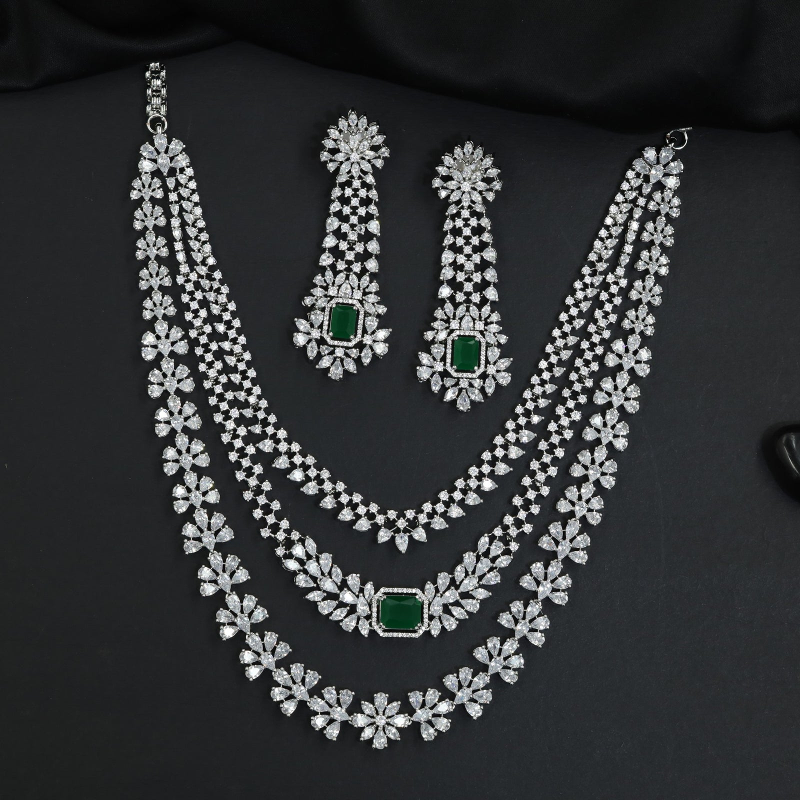 Statement silhouette rhodium necklace set with cascading strand detailing