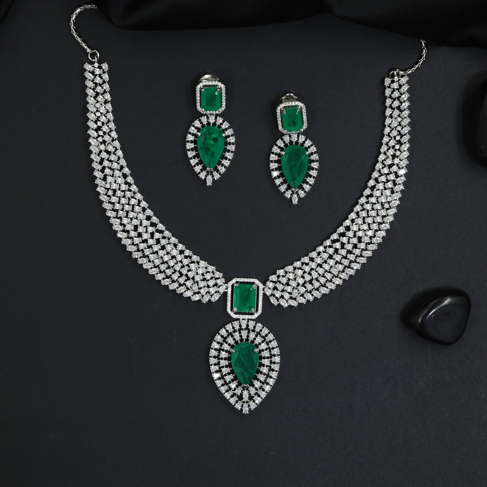 Traditional multi-row pave band rhodium necklace set with a teardrop pendant