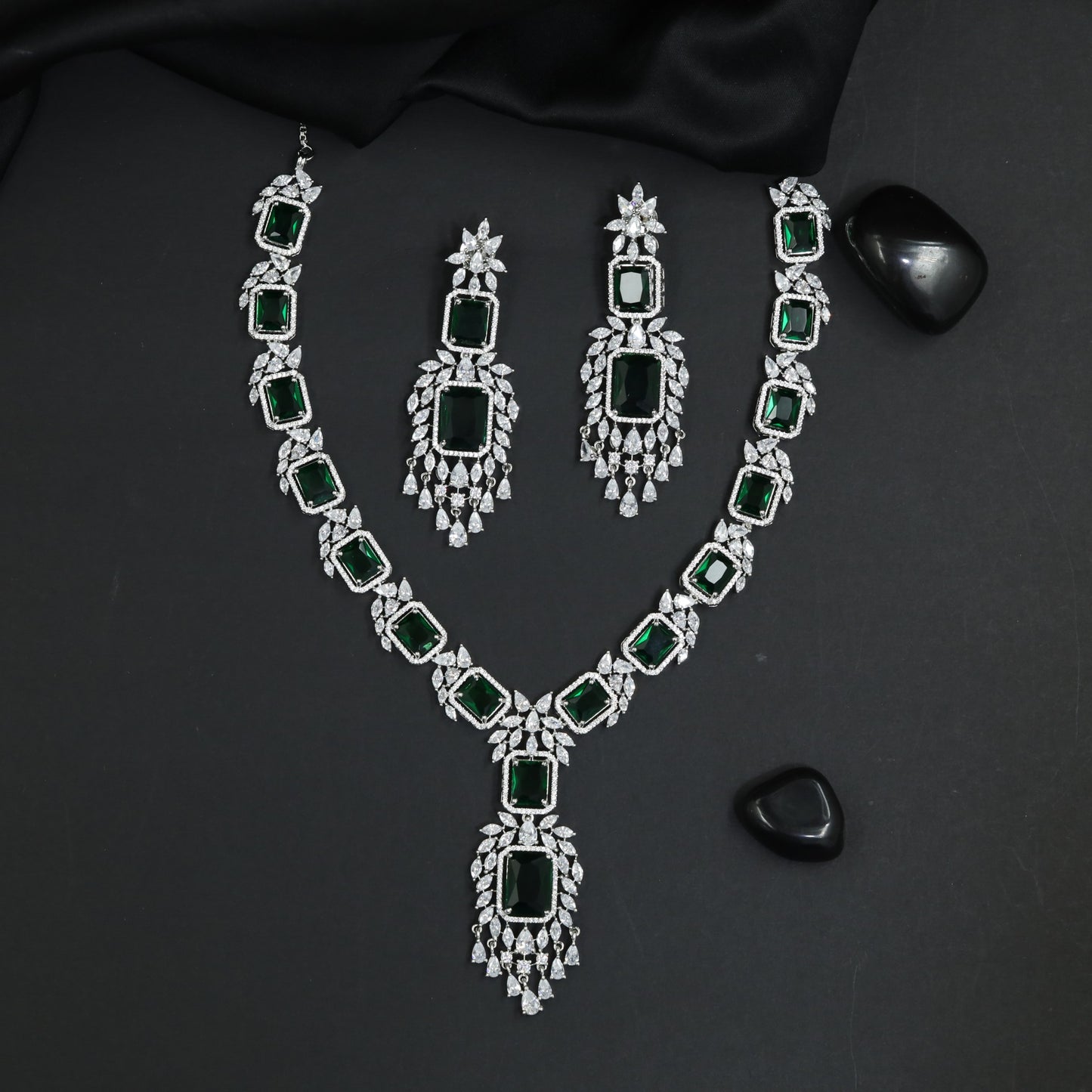 Bold rhodium long haara featuring statement gemstone silhouette