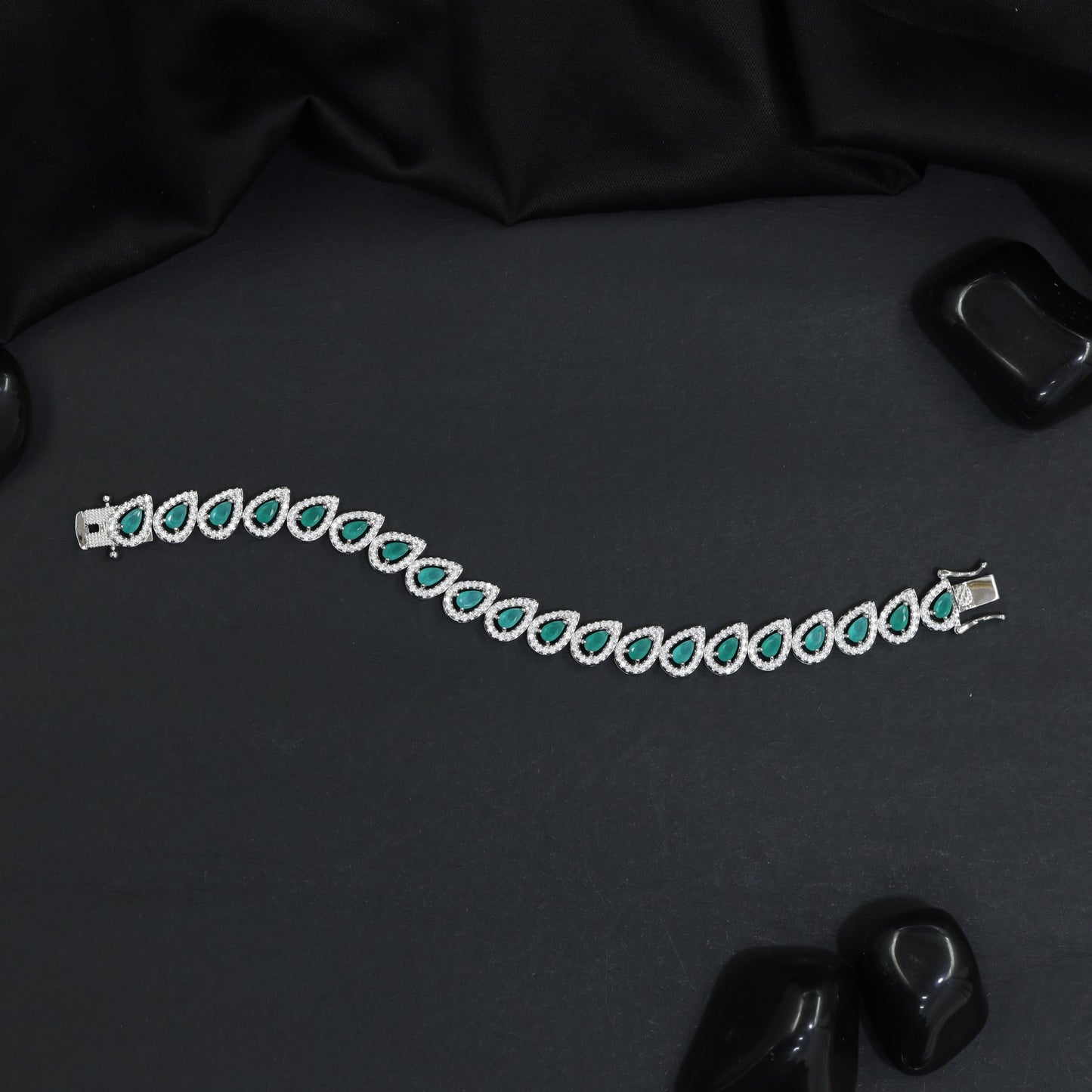 Rhodium Bracelet Featuring Decorative Leaf Links and Continuous Flow