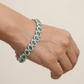 Rhodium Bracelet Featuring Decorative Leaf Links and Continuous Flow