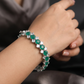 Stylish rhodium bracelet with emeraldâ€‘tone square highlights