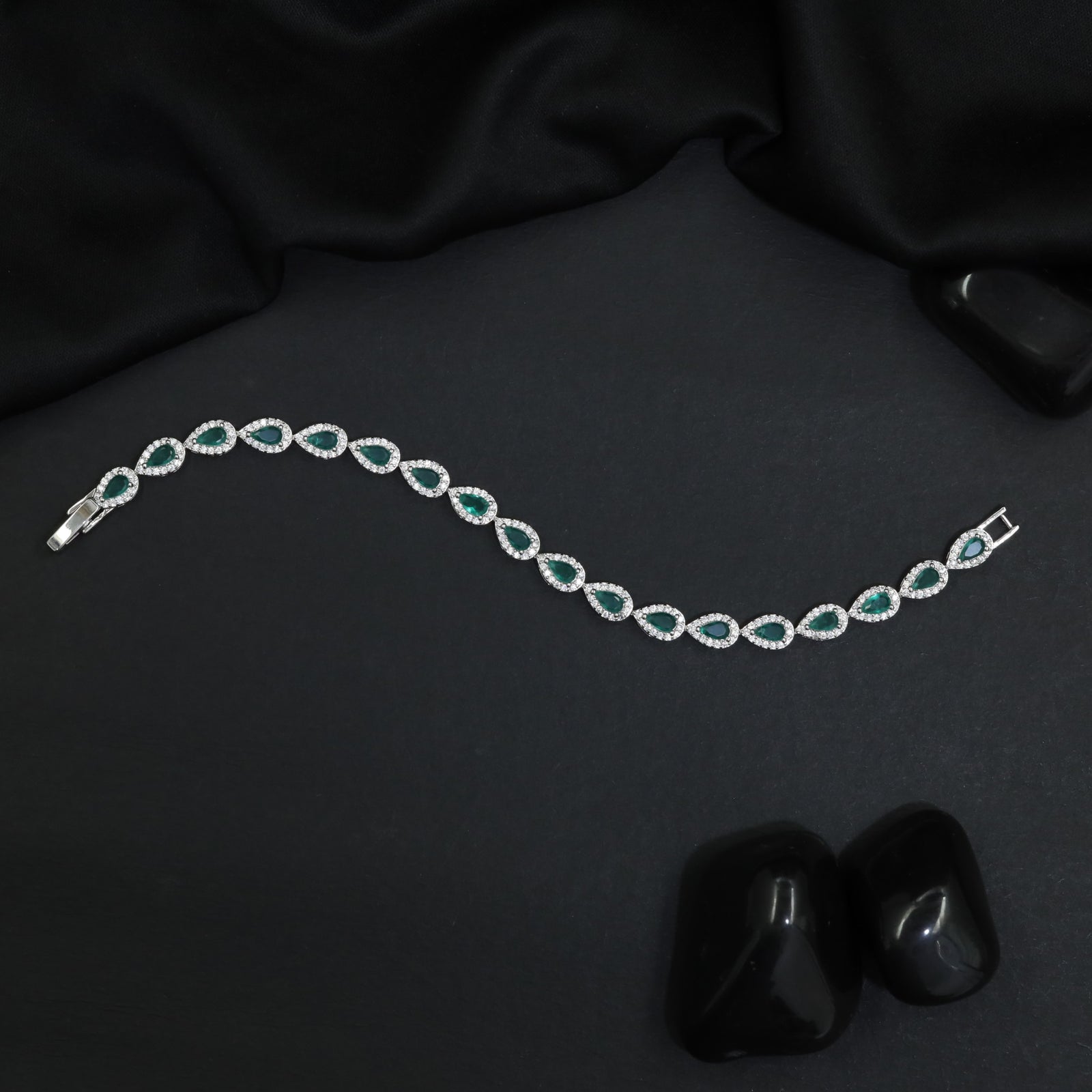 Iconic rhodium bracelet featuring gemstone crest accents