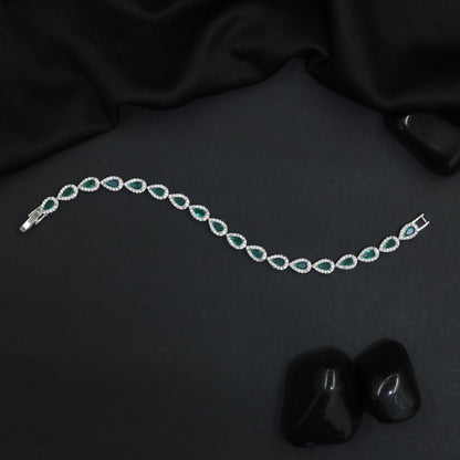 Iconic rhodium bracelet featuring gemstone crest accents