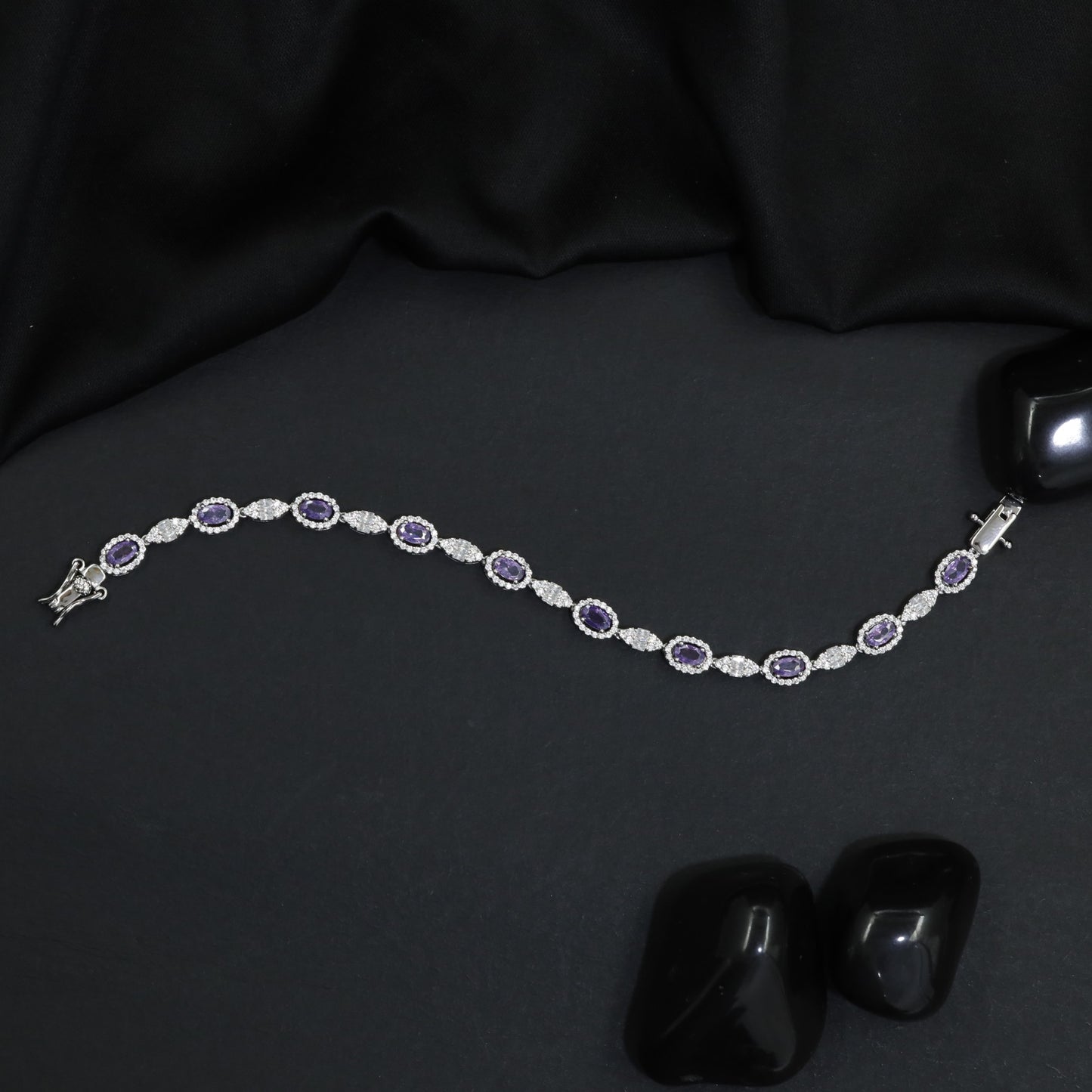 Rhodium Bracelet with Repeating Circular Elements and Decorative Leaf Links