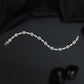Rhodium Bracelet with Repeating Circular Elements and Decorative Leaf Links