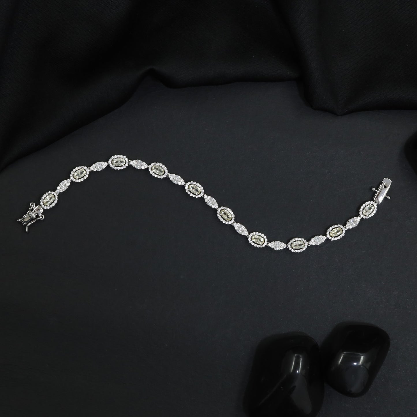 Rhodium Bracelet with Repeating Circular Elements and Decorative Leaf Links