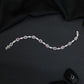 Rhodium Bracelet with Repeating Circular Elements and Decorative Leaf Links