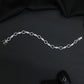 Rhodium Bracelet with Repeating Circular Elements and Decorative Leaf Links
