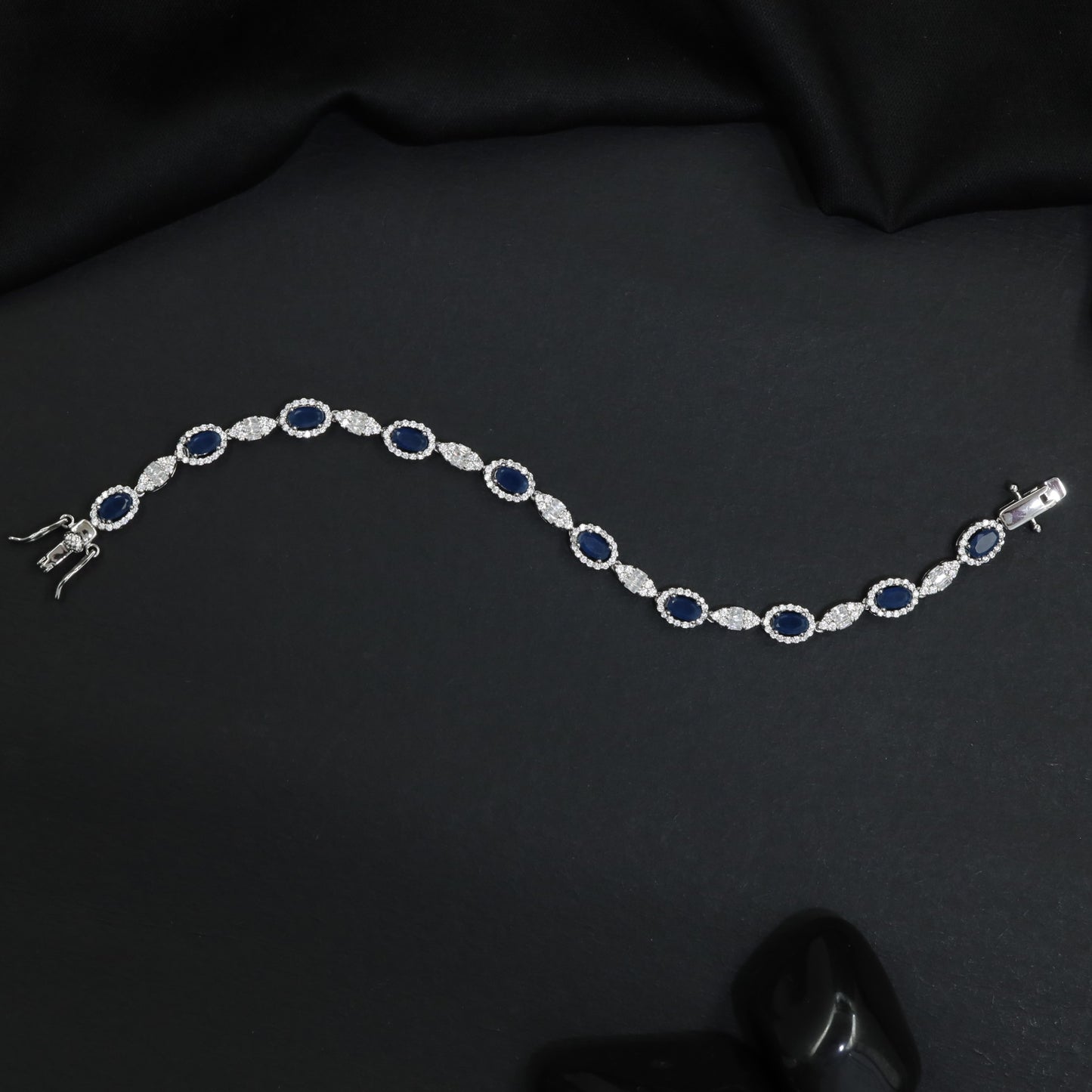 Rhodium Bracelet with Repeating Circular Elements and Decorative Leaf Links