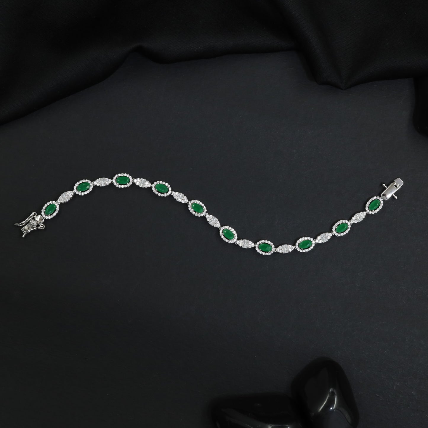 Rhodium Bracelet with Repeating Circular Elements and Decorative Leaf Links