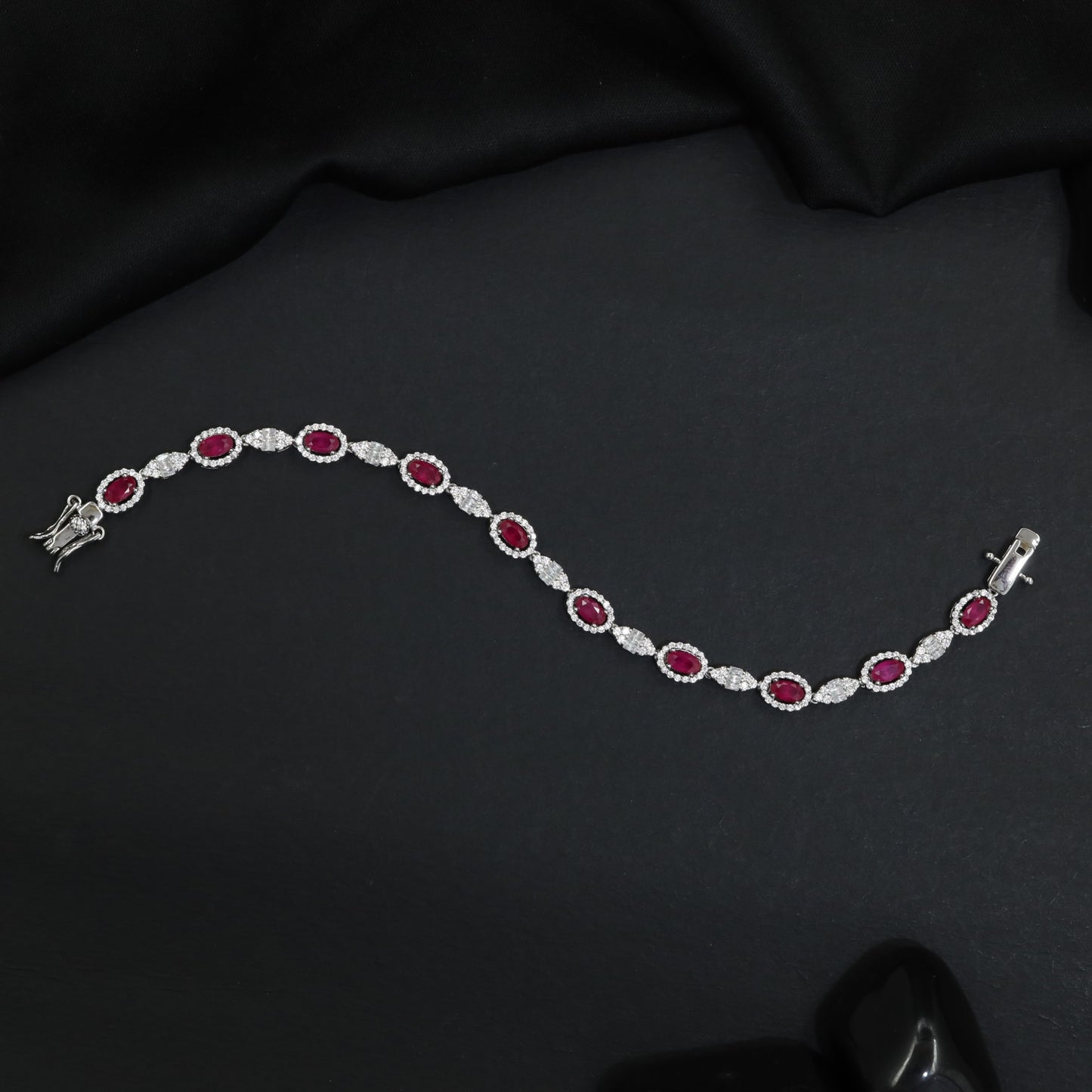 Rhodium Bracelet with Repeating Circular Elements and Decorative Leaf Links
