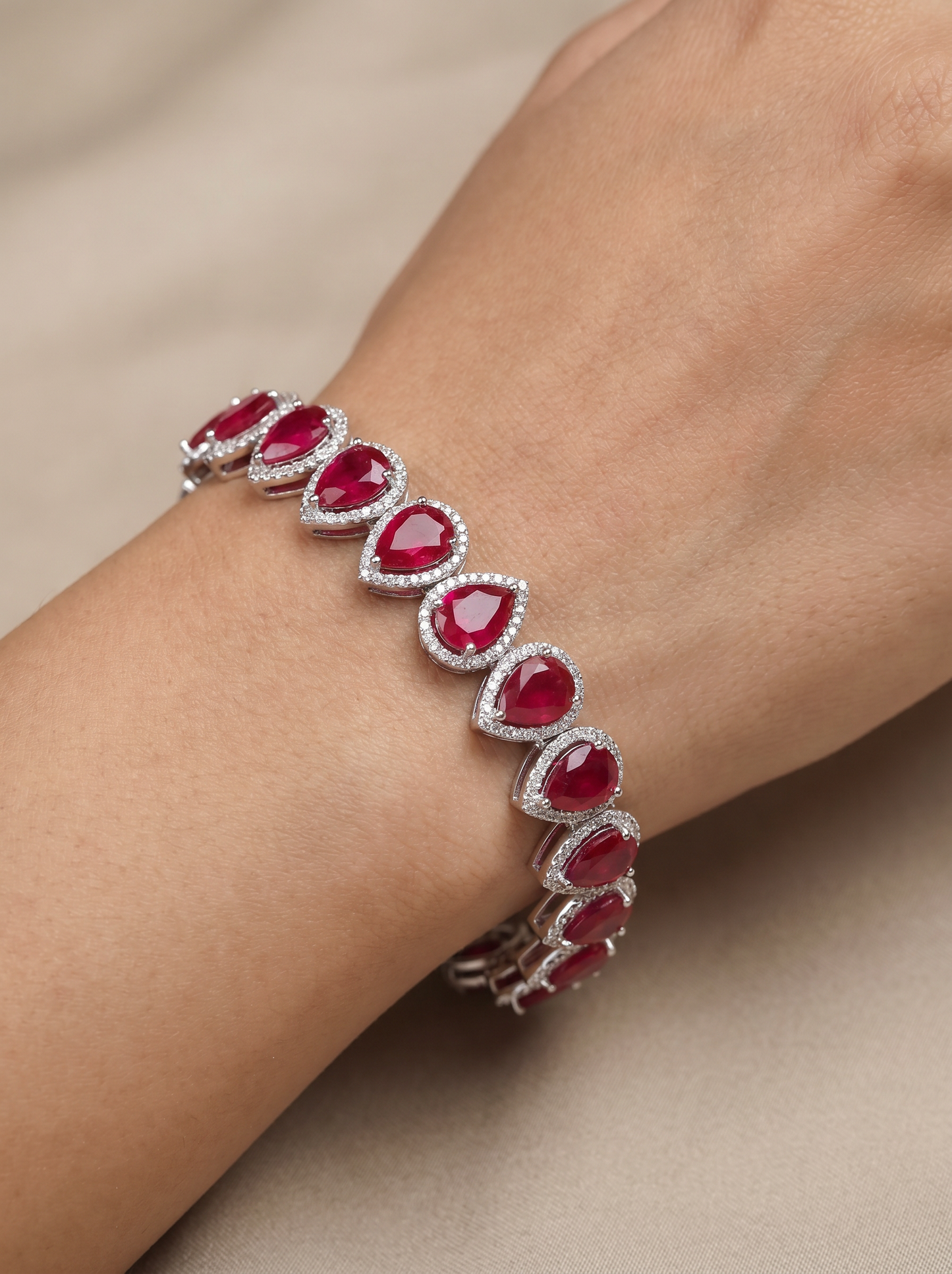 Rhodium Bracelet Featuring Oval Halo Stations and Teardrop Motifs