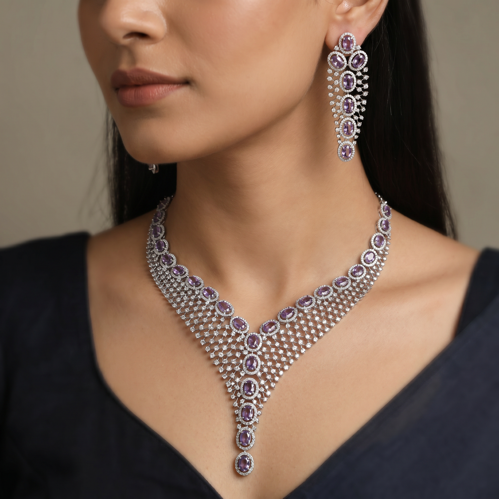 Rhodium necklace with graduated rosette arrangement and pendant drop