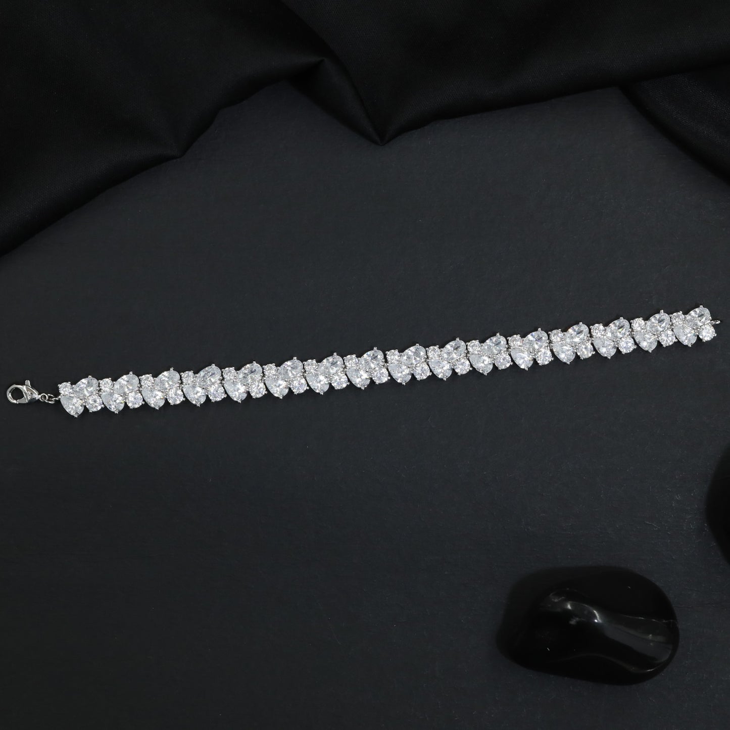 Rhodium Bracelet Showcasing Alternating Pear Clusters