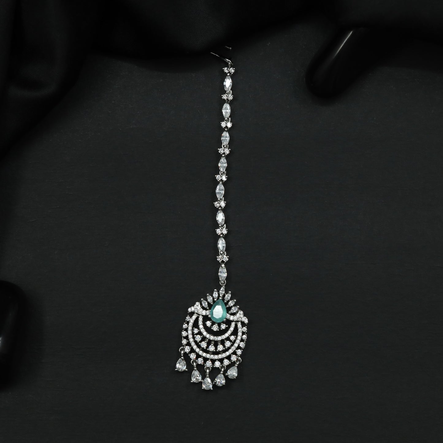 Tikka Featuring Decorative Crescent Pattern and Fringe Elements