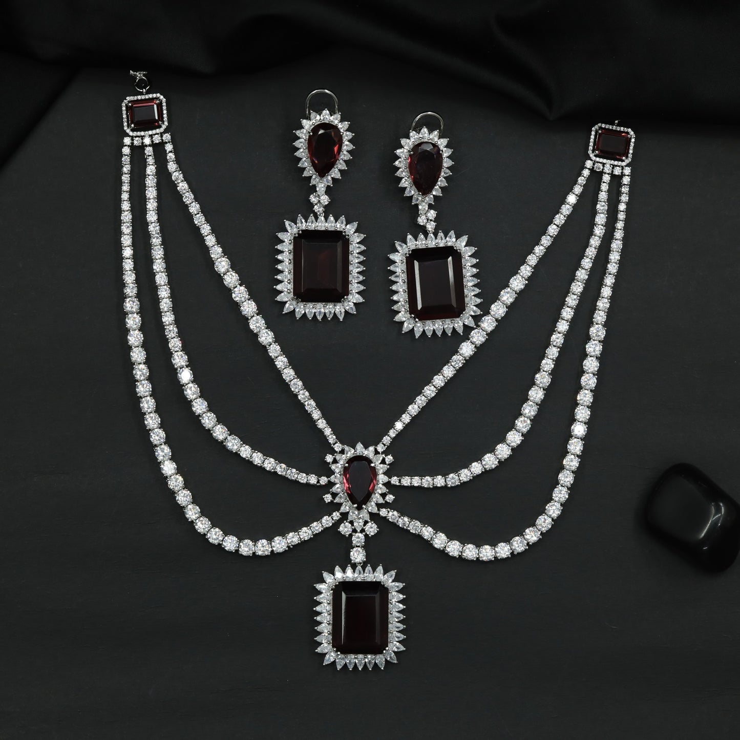 Rhodium Necklace Featuring Geometric Pendants and Triple Strand Construction