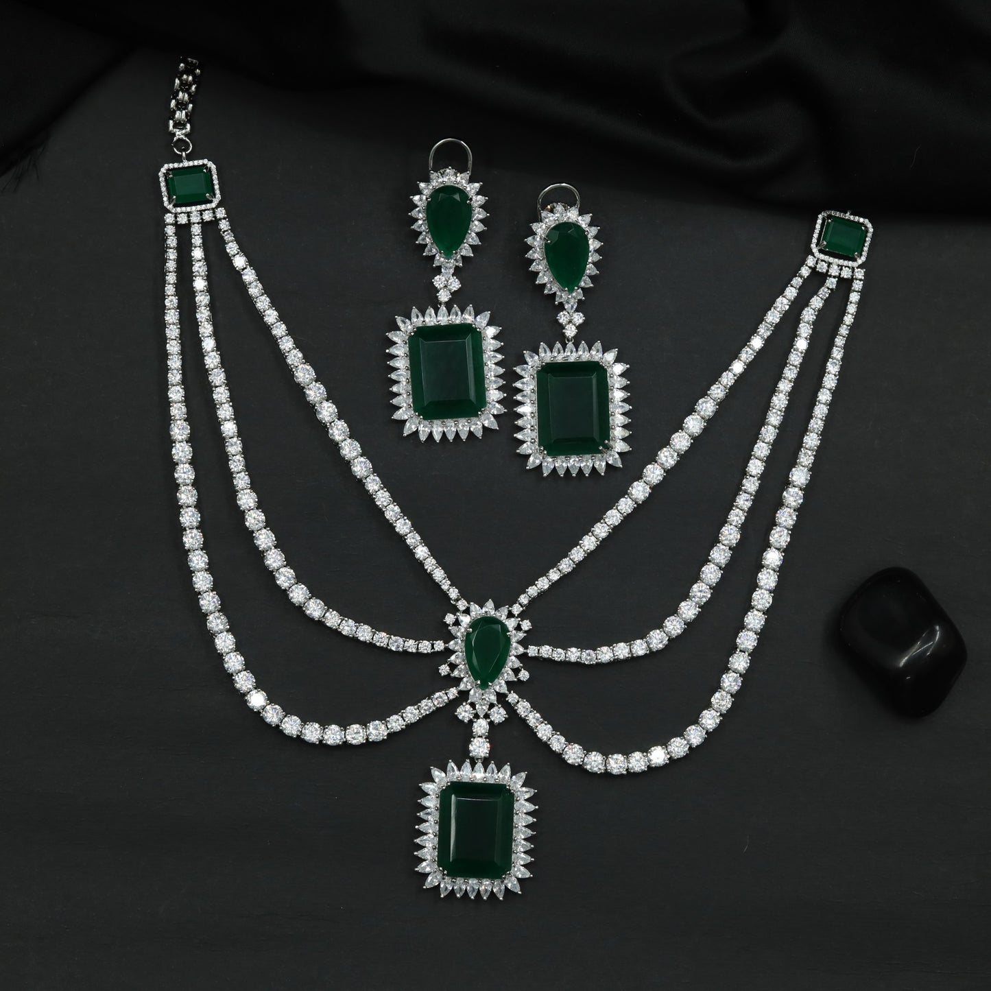 Rhodium Necklace Featuring Geometric Pendants and Triple Strand Construction