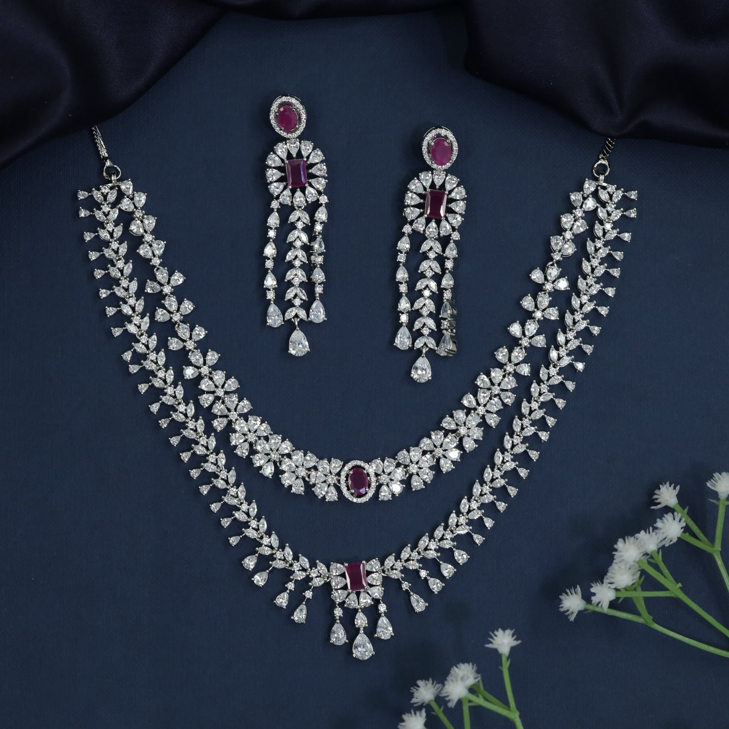 Rhodium necklace with draped collar styling and statement drop centerpiece