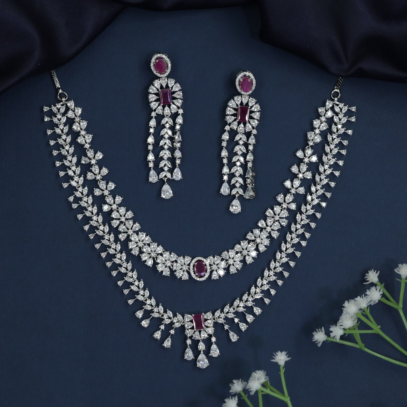 Rhodium necklace with draped collar styling and statement drop centerpiece