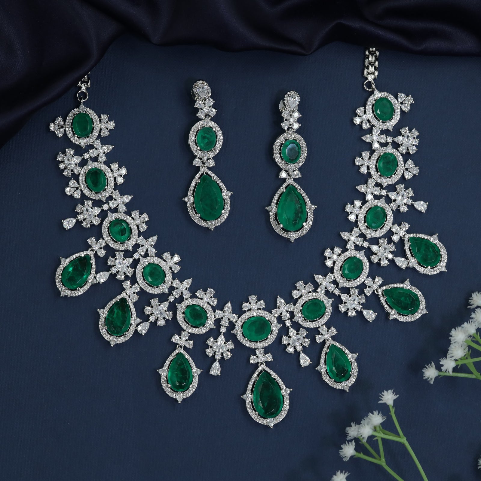 Statement rhodium necklace with daisy-inspired stations and teardrop accents
