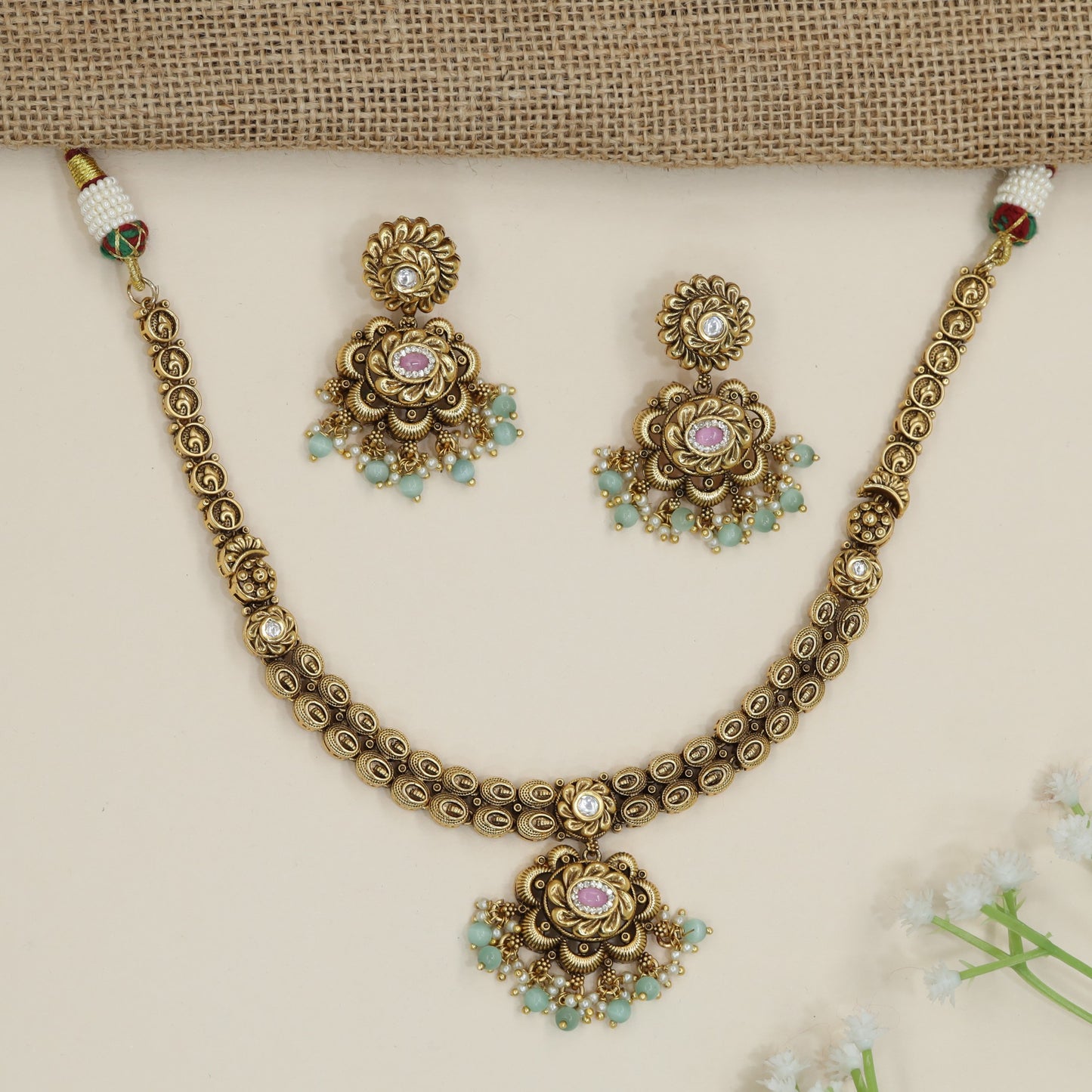 Traditional flower pendant necklace with ornate border detailing