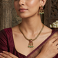 Parrot motif necklace with braided chain silhouette and dangling accents