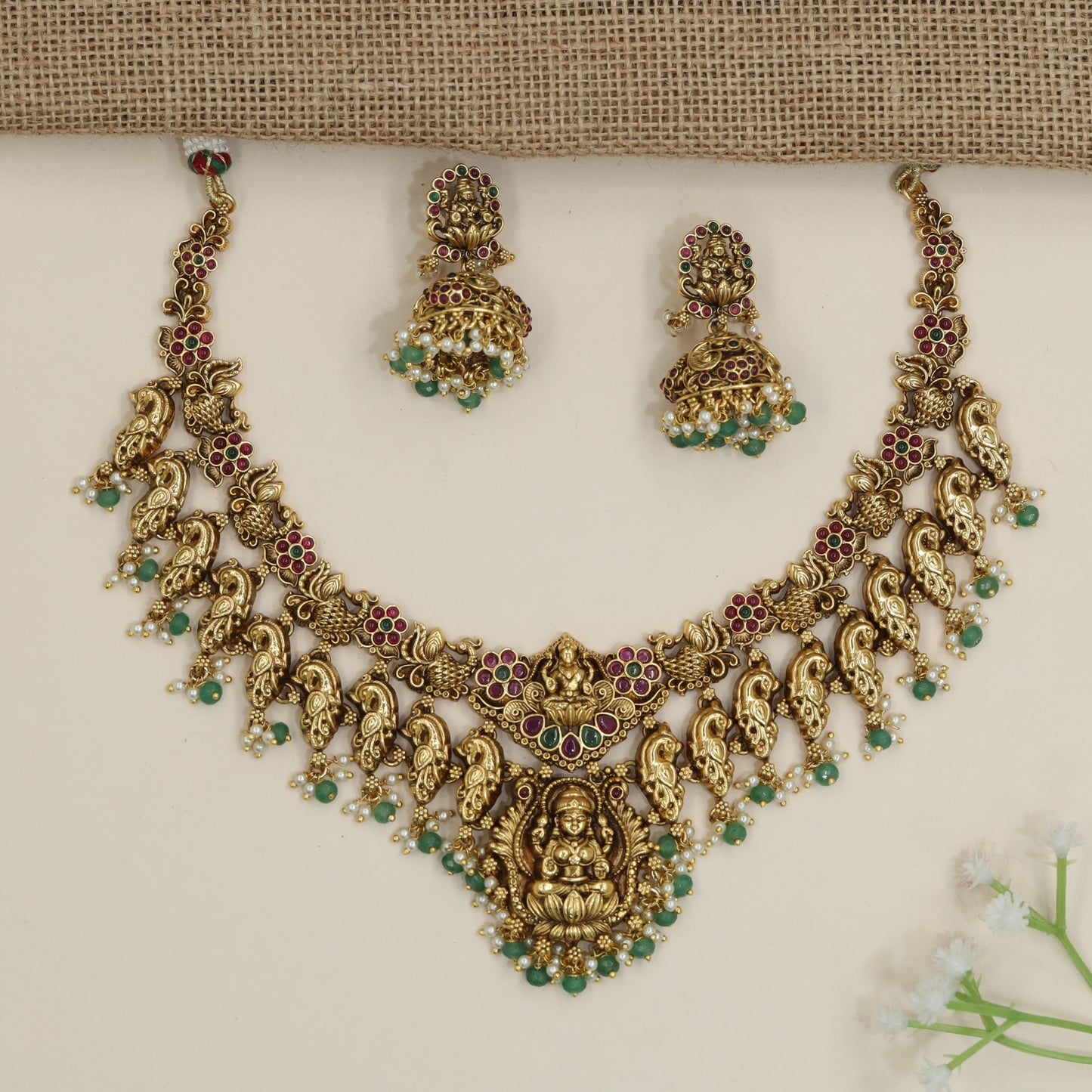 Artisan peacock motif necklace with sculpted Lakshmi centrepiece