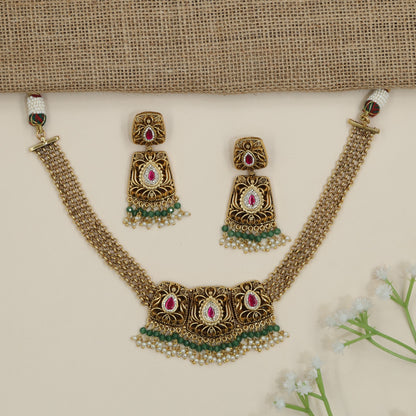 Regal scrollwork panel necklace with layered chain silhouette