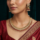 Artisan teardrop necklace with richly textured ornamental design