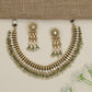 Artisan teardrop necklace with richly textured ornamental design