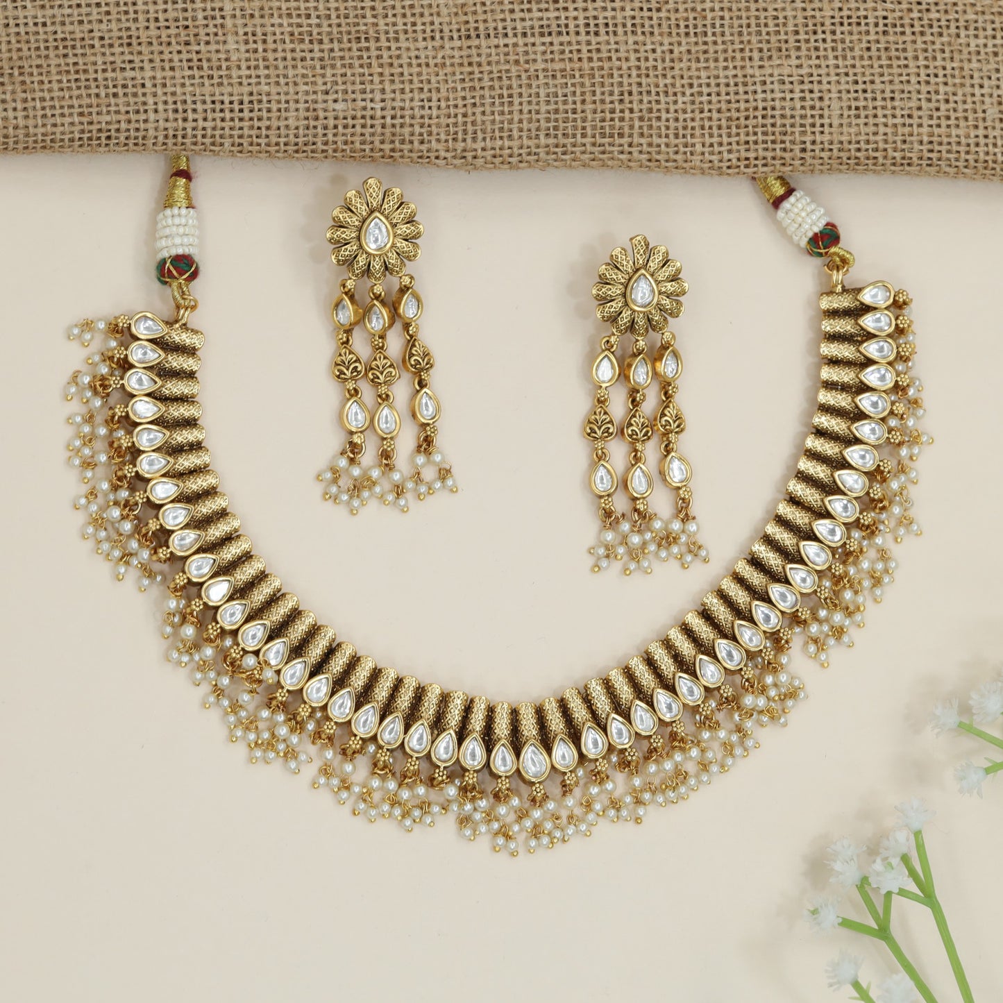 Artisan teardrop necklace with richly textured ornamental design
