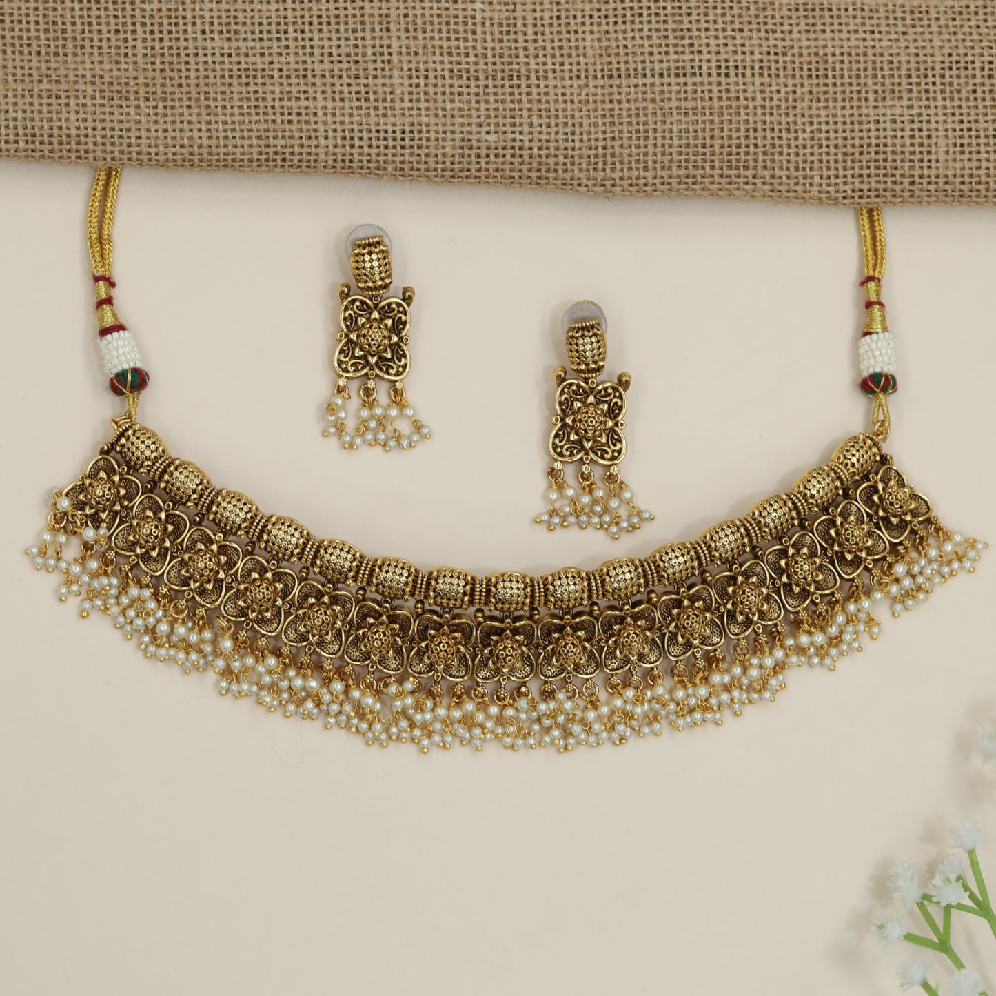 Festive floral necklace with layered motif arrangement and fringe detailing