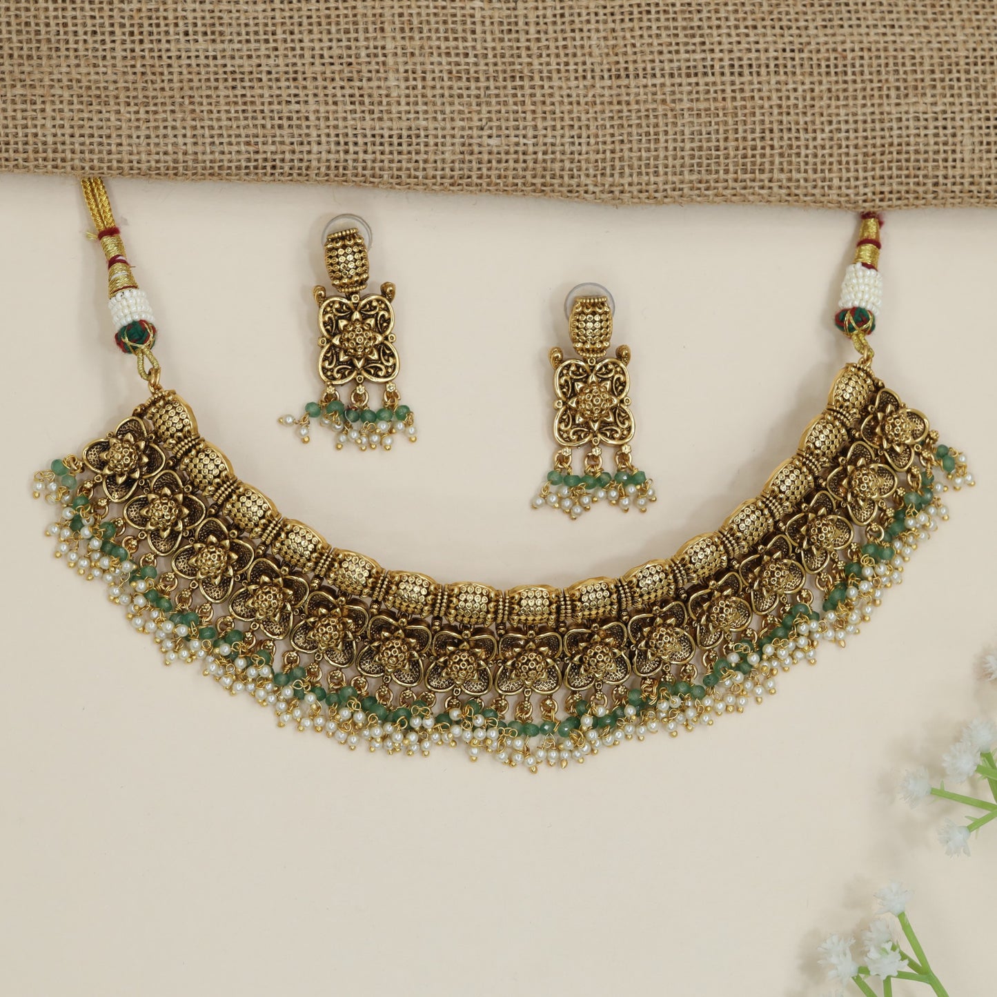 Festive floral necklace with layered motif arrangement and fringe detailing