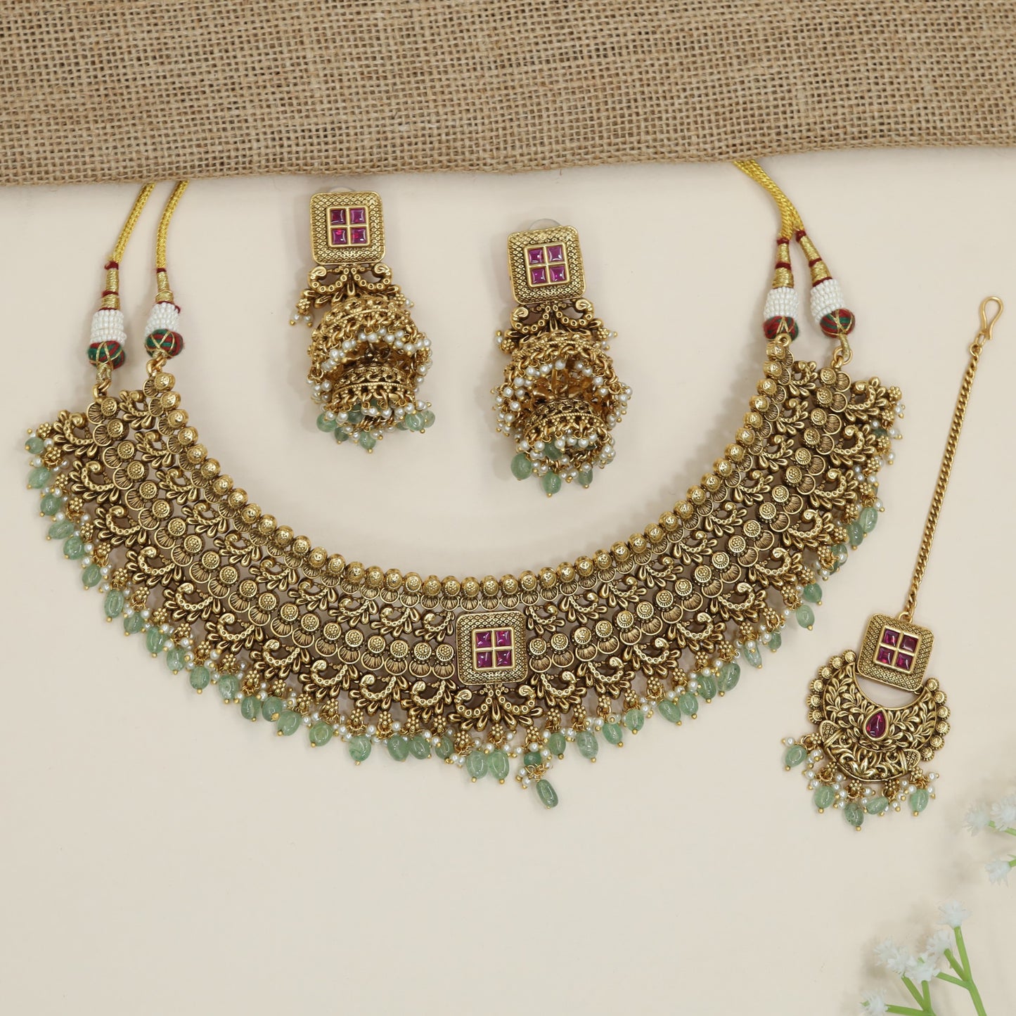 Grand heritage collar necklace with repeating floral coin motifs