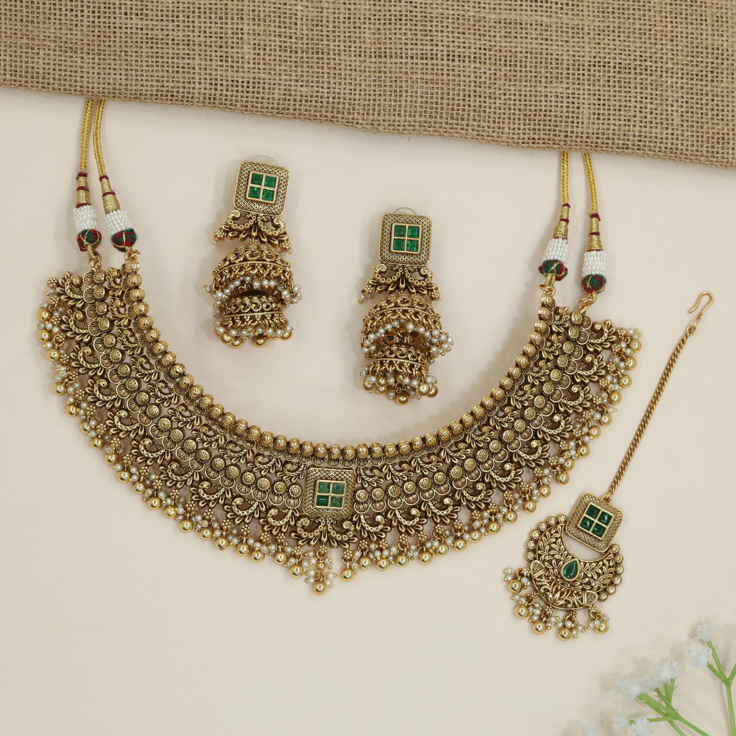 Grand heritage collar necklace with repeating floral coin motifs