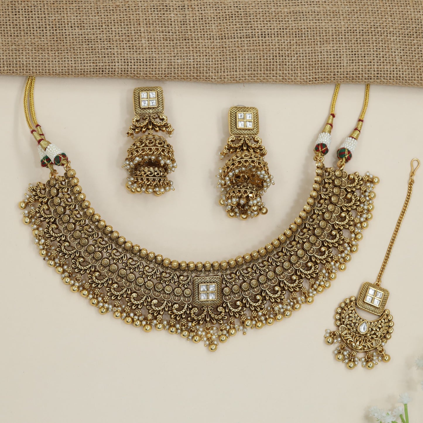 Grand heritage collar necklace with repeating floral coin motifs