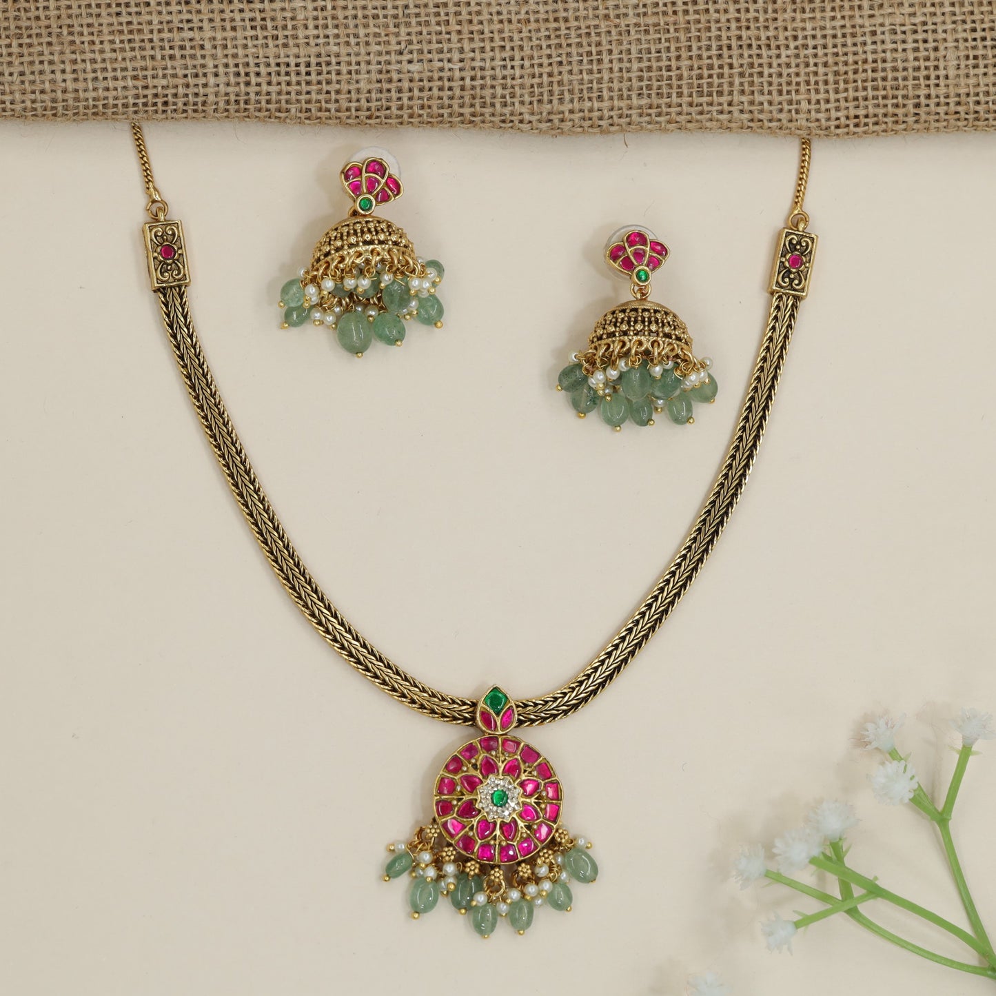 Regal braided chain necklace with floral medallion pendant