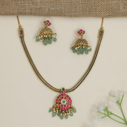 Regal braided chain necklace with floral medallion pendant