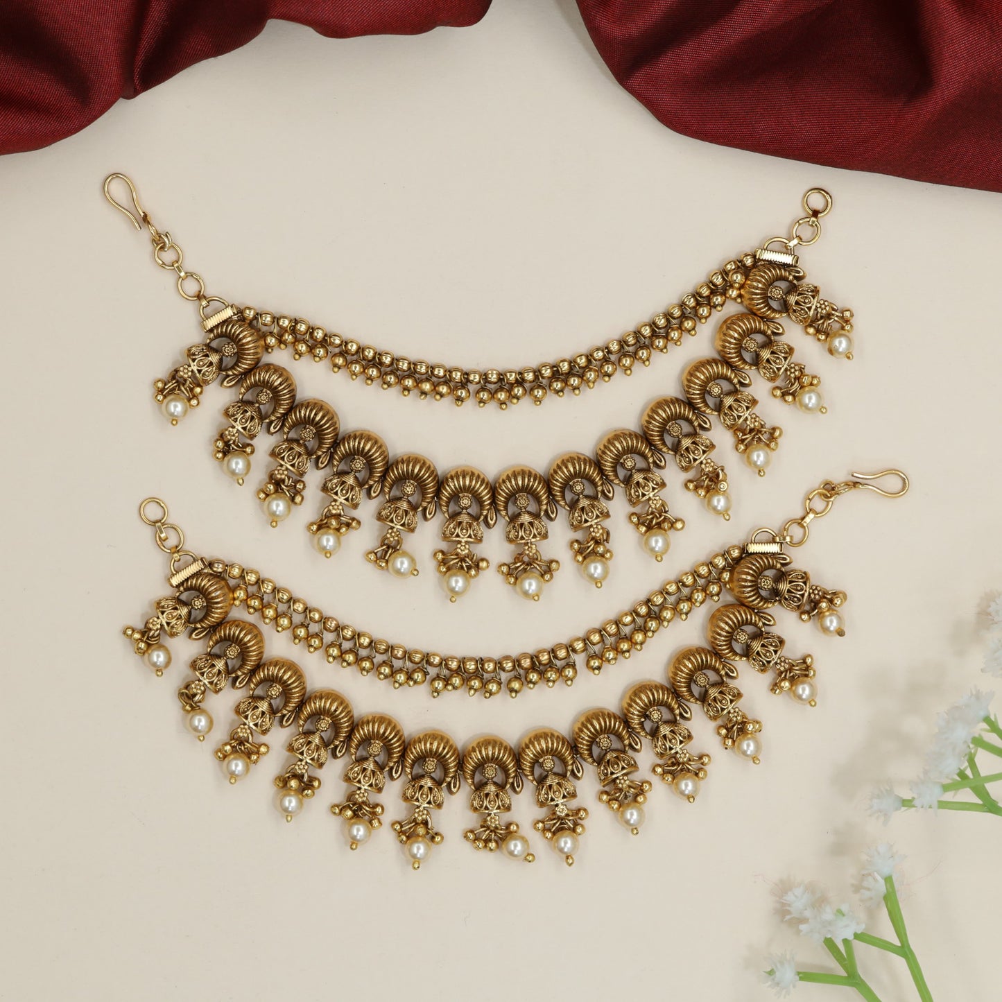 Curved horn motif Antique Mati with ornamental fringe accents