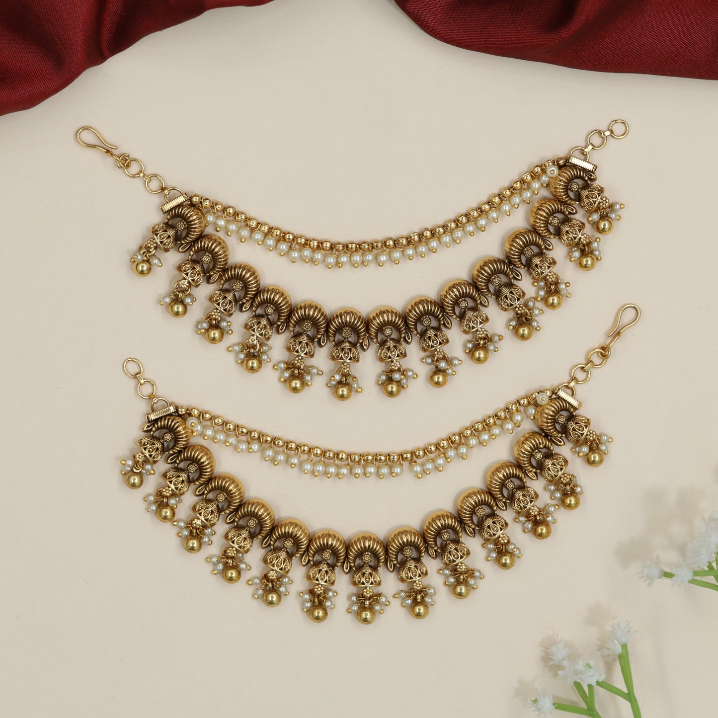Curved horn motif Antique Mati with ornamental fringe accents