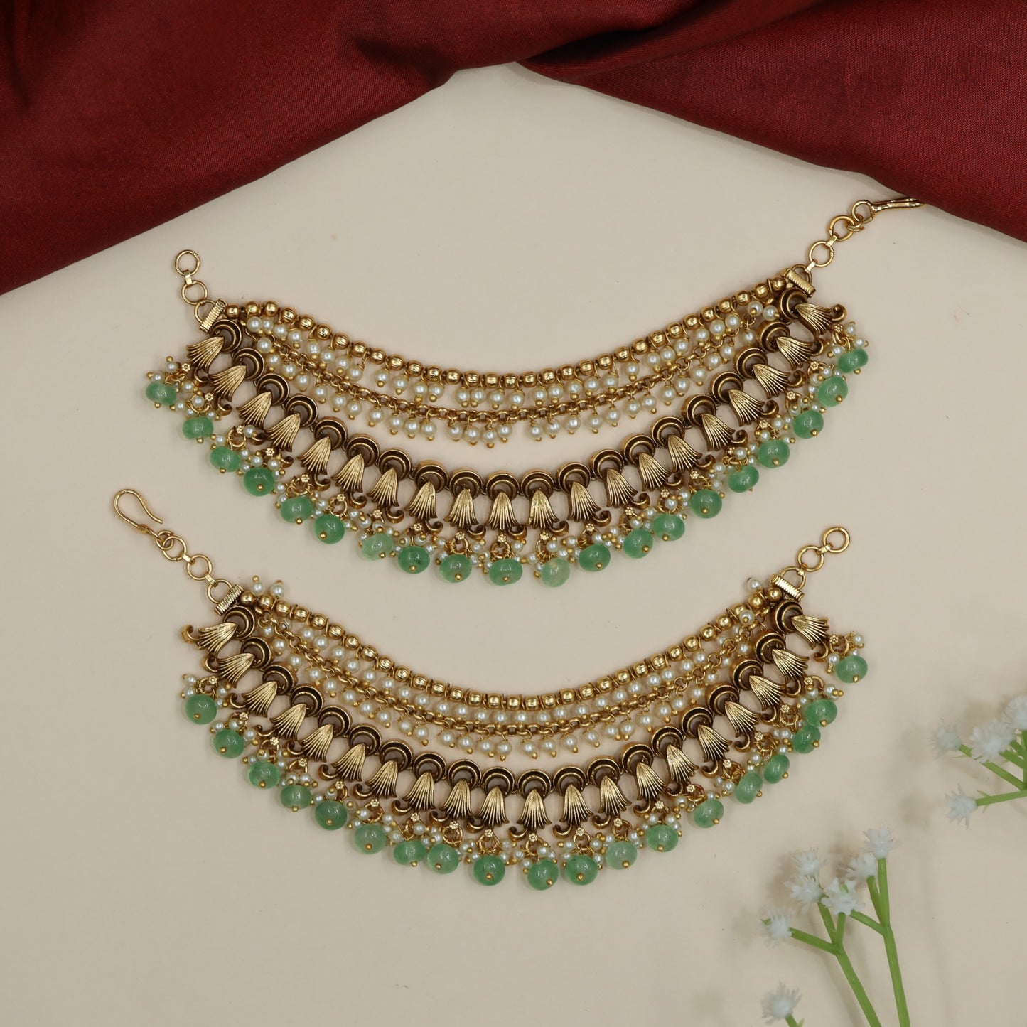 Traditional mati design with shell-inspired elements and bead fringe