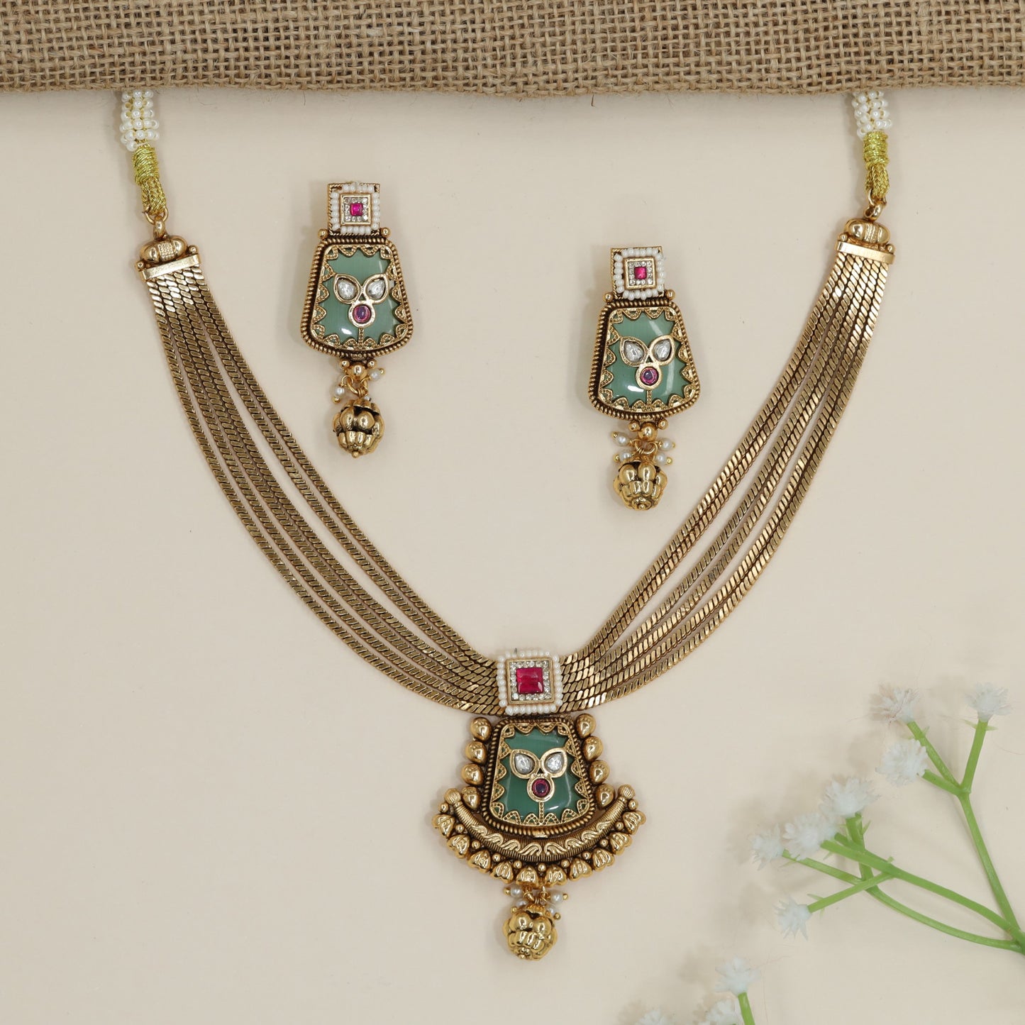 Handcrafted Kundan Necklace Styled with Uniform Multi-Strand Bands and Grooved Balls