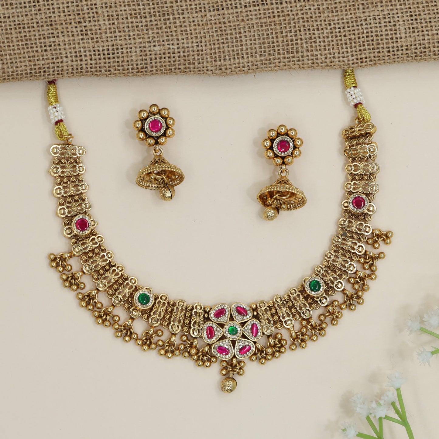 Royal Kundan Necklace Featuring Interlinked Hourglass Frames and Hanging Orbs