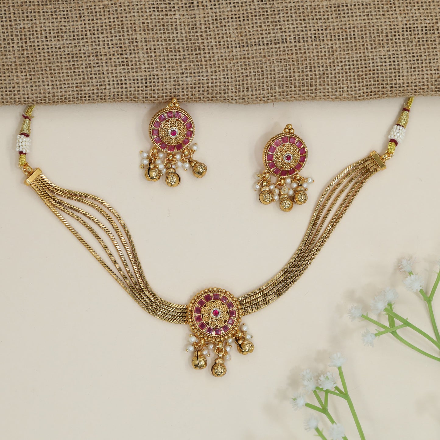 Festive disc motif choker with layered collar silhouette