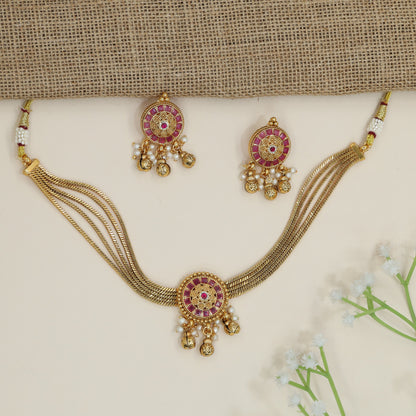 Festive disc motif choker with layered collar silhouette