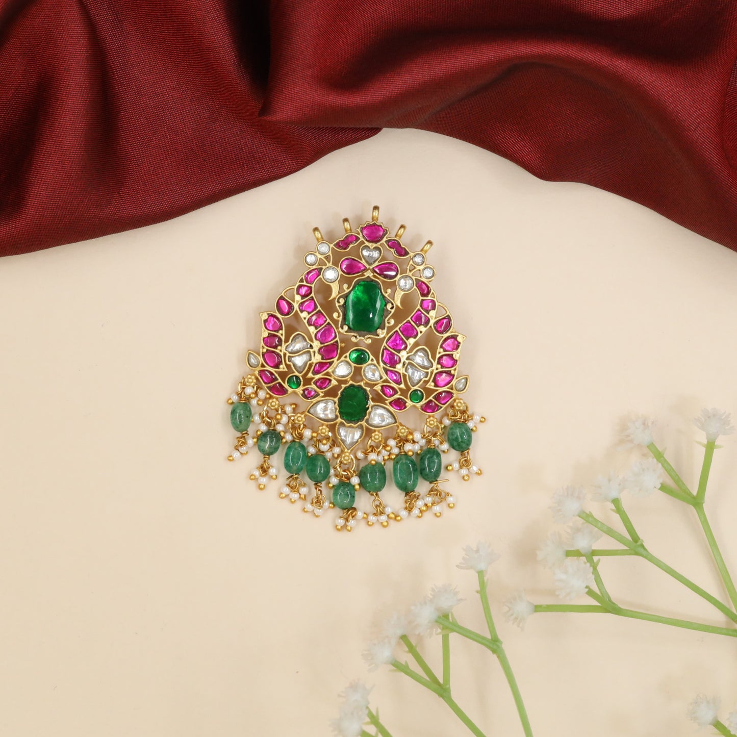 Peacock jadau pendant with floral centerpiece and bead fringe