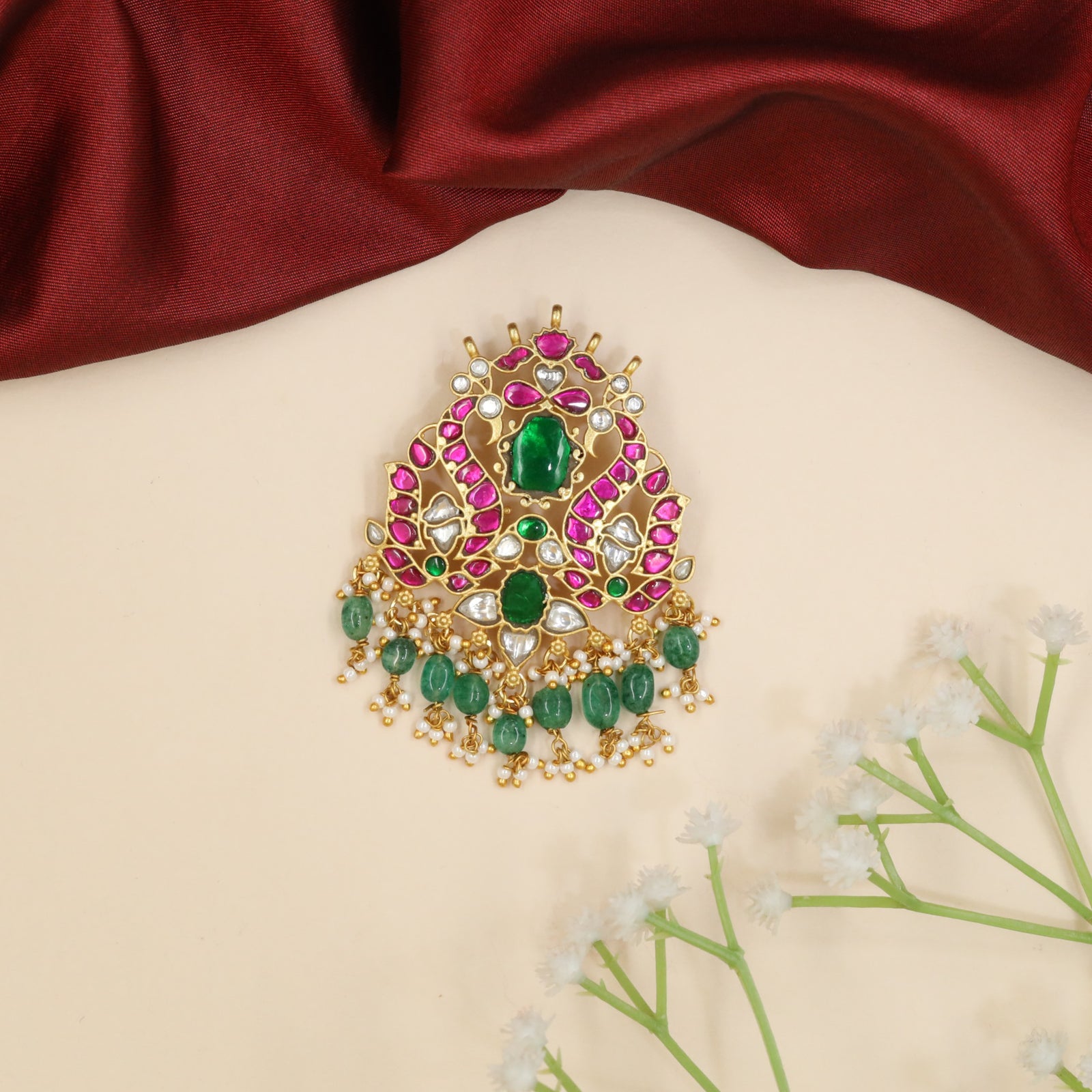 Peacock jadau pendant with floral centerpiece and bead fringe